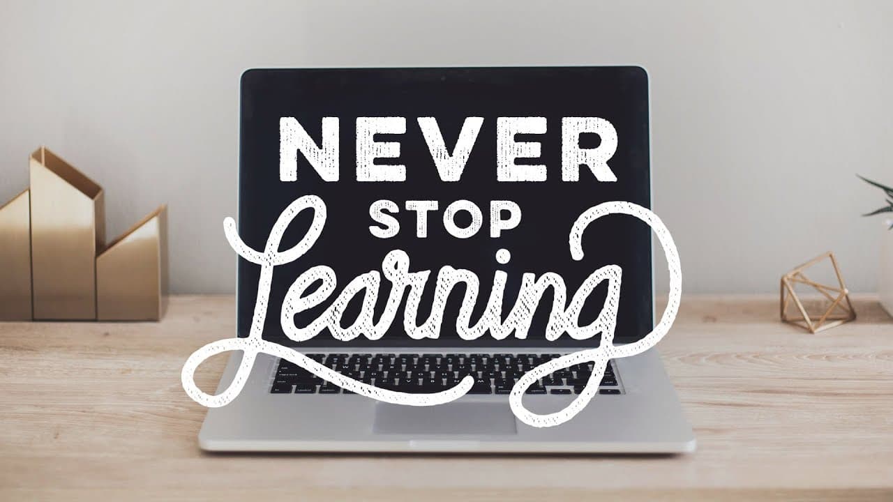 A laptop screen with a quote 'never stop learning'